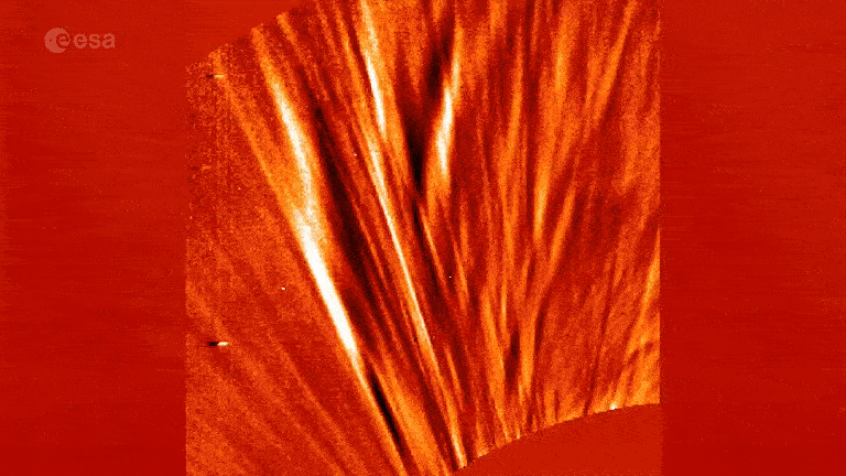 Looped video footage of swirling solar wind shooting out of the sun with UFO-like lines moving across the screen 
