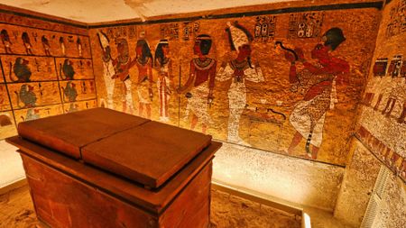 a view inside King Tut's tomb with murals on the walls