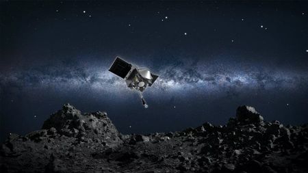 An artist's illustration of the OSIRIS-REx spacecraft poised to land on the asteroid Bennu.