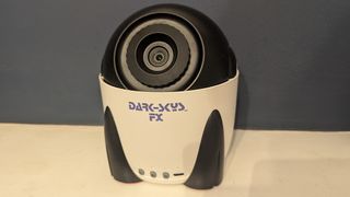 Dark Skys DS-FX Star Projector on a white shelf in front of a blue wall