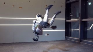 A photo of a humanoid robot captured during a side flip.